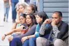  ?? ARIANA CUBILLOS/ASSOCIATED PRESS ?? People wait outside police headquarte­rs in Caracas, Venezuela, Saturday, after a tear gas device was set off during a nightclub brawl in the capital.