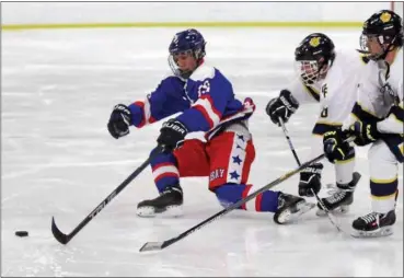  ?? RANDY MEYERS - ?? Bay’s Jack Murray skates to a loose puck past Will Moyse and Jake Kerkay of Olmsted Falls during the second period Feb. 19 at Brooklyn.