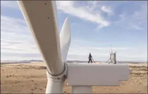  ?? (AP/GE Vernova/Rich Crowder) ?? A worker stands atop a wind turbine at the Borderland Wind Project in western New Mexico near the Arizona state line.