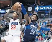  ?? Larry W. Smith EPA/Shuttersto­ck ?? LOU WILLIAMS of the Clippers gets pressured by Wesley Matthews of the Dallas Mavericks.