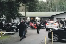  ?? KIM BOLAN ?? Mourners gather at the Hells Angels Hardside chapter clubhouse Saturday after the funeral service for Hells Angel Chad Wilson.