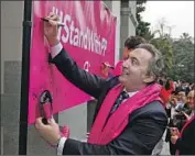  ?? Rich Pedroncell­i Associated Press ?? REP. AMI BERA (D-Elk Grove) signs a banner supporting Planned Parenthood at the Capitol in 2017.