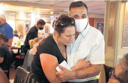  ?? CARLINE JEAN/SOUTH FLORIDA SUN SENTINEL ?? Erin Celia, of Fort Lauderdale, who has been a customer for 35 years, cries as she hugs owner Vinny Esposito on Monday at Franco & Vinny’s on Sunrise Boulevard. The restaurant is closing after 50 years in business with Esposito’s retirement at age 79.