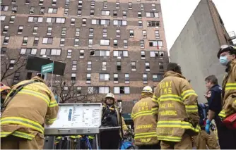  ?? ?? Firefighte­rs work at the scene of a fatal fire at an apartment building in the Bronx on Sunday in New York. At least 19 people were killed and dozens injured after a fire tore through a high-rise apartment building.
