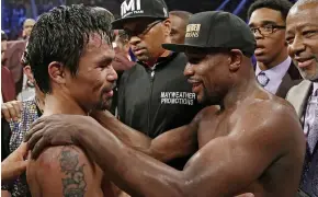  ??  ?? Ceasefire: Pacquiao (left) and Mayweather embrace after the fight