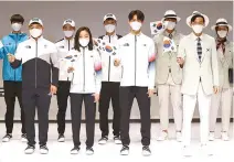  ?? Yonhap ?? Athletes of the Korean national team pose in their new training wears and suits for the Tokyo Olympics at the unveiling event at the National Training Center in Jincheon, Wednesday.