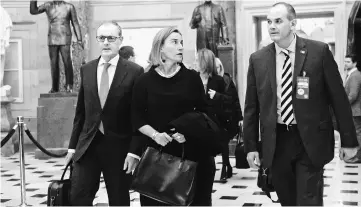  ??  ?? Mogherini (centre) walks through the US Capitol between meetings in Washington, DC. — AFP photo