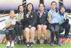  ??  ?? Top three winners in the women’s doubles posing for a group photograph after receiving their medals.