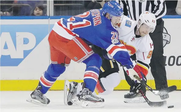  ?? — ASSOCIATED PRESS FILES ?? The Calgary Flames’ Sam Bennett battles the New York Rangers’ Derek Stepan for the puck during NHL action Sunday in New York. The Rangers scored three goals in the third period to record a 4-3 victory over the visitors.