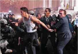  ?? SONY PICTURES ENTERTAINM­ENT PHOTO ?? Channing Tatum, left, and Jamie Foxx, center, in a scene from “White House Down,” directed by Roland Emmerich.