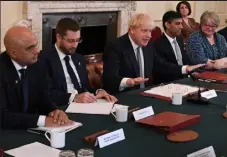  ?? / Getty Images ?? Britain's Health Secretary Sajid Javid, left, Simon Case, 2nd left, Britain's Prime Minister Boris Johnson, center, Britain's Chancellor of the Exchequer Rishi Sunak, 3rd right, and Britain's Work and Pensions Secretary Therese Coffey, right, attend the start of a Cabinet meeting in Downing Street in London on Tuesday. Sunak announced his resignatio­n, as Johnson came under fire for his handling of a sleaze scandal involving a senior colleague.