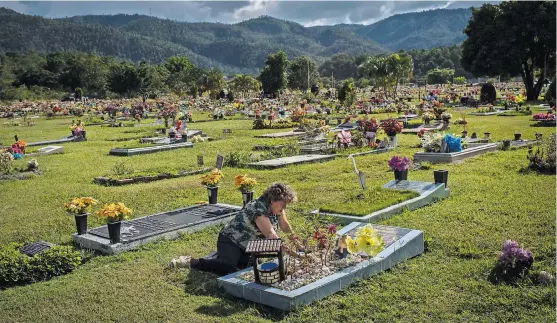  ?? DANIELE VOLPE FOR THE NEW YORK TIMES; BELOW, DEPARTMENT OF THE TREASURY OFFICE OF FOREIGN ASSETS CONTROL ?? Hilda Caldera at the grave of her husband, Alfredo Landaverde, a Honduran official killed after exposing government corruption.