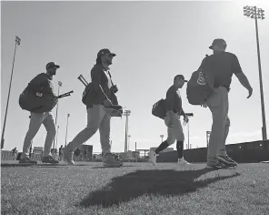  ?? JAE C. HONG/ AP ?? The Cubs walk across the field during a workout Saturday in Arizona. Javy Baez, Kris Bryant and Anthony Rizzo can be free agents after the season.