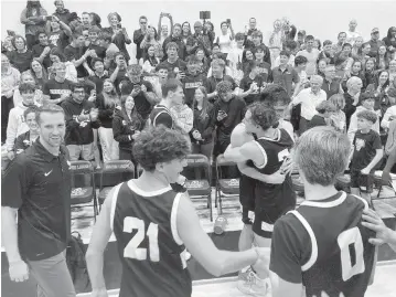  ?? BILL DALEY Special to the Miami Herald ?? North Broward Prep players congratula­te each other after beating Mater Lakes in a Region 4-4A basketball final Friday at Mater Lakes. The Eagles will play St. Petersburg’s Gibbs (25-5) in a Class 4A game at 11 a.m. Thursday in Lakeland.