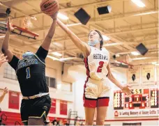  ?? VINCENT D. JOHNSON/DAILY SOUTHTOWN ?? Marist’s Elise Ward, right, and Simeon’s Laureal Jackson battle for a rebound.