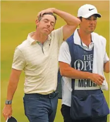  ?? AP PHOTO/GERALD HERBERT ?? Rory McIlroy of Northern Ireland walks from the 18th green with his caddie after finishing his final round of the British Open championsh­ip on Sunday.