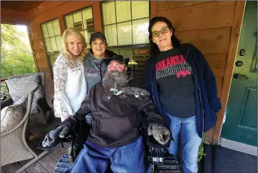  ?? NWA Democrat-Gazette/FLIP PUTTHOFF ?? A motorized chair gets Steve Swope into the woods or wherever he wants to go. With Swope are Jennifer Necessary (from left), director of the Arkansas ALS Associatio­n chapter; Swope’s wife, Jackie; and his mom, Alma Swope.