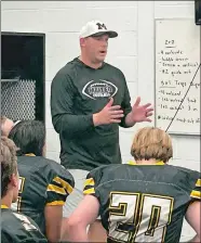  ?? MIKE DIMAURO/THE DAY ?? Brian Emery talks to his players prior to taking the field for time in 2023 at Manteo High School on the Outer Banks of North Carolina. Emery, 34, is the son of exMontvill­e and Fitch head coach Mike Emery, who serves as an assistant on his son’s coaching staff.