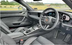  ??  ?? The 911’s interior is attractive­ly simple and almost brutally sensible in its layout.