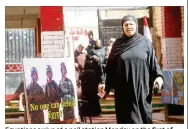  ?? SALAH MALKAWI / GETTY IMAGES ?? Egyptians arrive at a poll station Monday on the first of three days of voting in Cairo. The vote is being held against the backdrop of a wide-ranging crackdown on dissent, with thousands of Islamists as well as several prominent secular activists in...