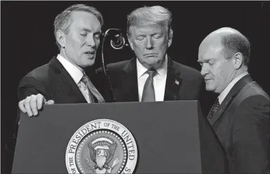  ?? [EVAN VUCCI/THE ASSOCIATED PRESS] ?? Rep. James Lankford, R-okla., left, President Donald Trump and Sen. Chris Coons, D-del., pray Thursday during the National Prayer Breakfast in Washington.