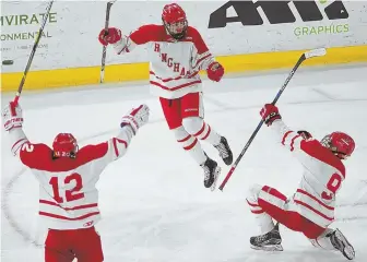  ?? STAFF PHOTO BY CHRISTOPHE­R EVANS ?? EXTRA EFFORT: Frankie Higgins (9) celebrates his overtime goal with Hingham teammates in last night’s 2-1 victory against Andover in the Super Eight.