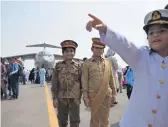  ?? AFP ?? People gather during celebratio­ns to mark the country’s Defence Day at the Nur Khan airbase in Rawalpindi; centre, a man takes selfie with his son in front of a plane; and, right, children dressed as armed forces personnel at the show. —
