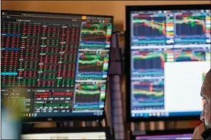  ?? (AP/Mary Altaffer) ?? A trader works Wednesday on the floor of the New York Stock Exchange shortly after the opening bell.