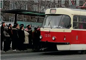  ?? AP ?? People queue to board a tram in Pyongyang. North Korea is upgrading its capital’s overcrowde­d mass transit system in a campaign intended to show that leader Kim Jong Un is raising the country’s standard of living.