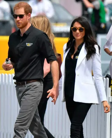  ??  ?? BREAKING THE MOULD: Harry and Meghan Markle on tour in Oz. Right, the fancy dress costume