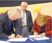  ?? ADOLPHE PIERRE-LOUIS/JOURNAL ?? CNM President Katharine Winograd, left, and McDonald’s Franchise Owner President and CEO Clemy Garza, sign their partnershi­p agreement.