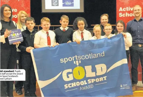  ??  ?? Gold standard Pupils and staff accept the award from Sport Scotland’s Steven Lytham