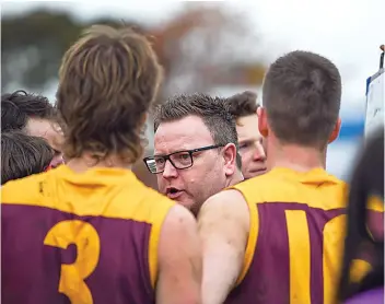  ?? Photograph­s by CRAIG JOHNSON. ?? Drouin senior coach Brent Clinnick addresses his players at quarter time.