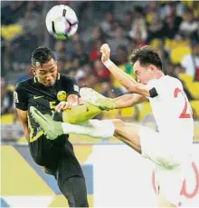  ??  ?? That’s mine: Malaysia’s Adam Nor Azlin (left) vying for the ball with Mongolia’s Tsedenbal Norjmoo during a friendly at the National Stadium in Bukit Jalil yesterday. — M. AZHAR ARIF/ The Star