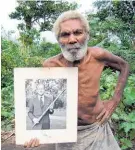  ?? Photo / Richard Shears, Shuttersto­ck ?? Jack Naiva with a picture of Prince Philip.