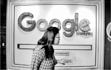  ??  ?? An employee walks past the Google logo in its Malaysian office in Kuala Lumpur. Google is testing a way to tie online ads to brick-andmortar store purchases, a move whetting marketing appetites while fueling privacy worries. Google is testing a way to...