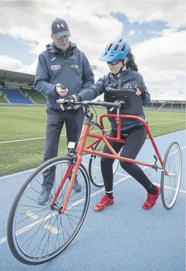  ?? ?? Dr Julie Mcelroy from Glasgow, pictured with her coach Gordon Innes, is aiming to become the first female frame runner to complete the London Marathon