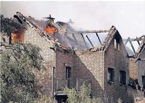  ?? FOTOS: DPA ?? Flammen schlagen aus den Dachstühle­n brennender Häuser an der Bahnstreck­e in Siegburg.
