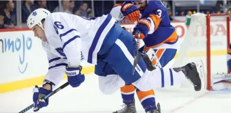  ?? BRAD PENNER/USA TODAY SPORTS ?? Islanders defenceman Travis Hamonic trips up Roman Polak of the Leafs in Sunday night’s one-sided contest at the Barclays Center.