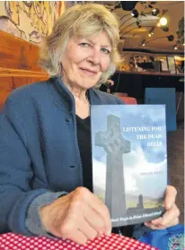  ?? SALLY COLE/THE GUARDIAN ?? Author Marian Bruce holds her new book, “Listening for the Dead Bells: Highland Magic in P.E.I.” It’s published by Island Studies Press.