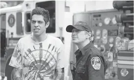  ??  ?? Scott Carlin ( Pete Davidson, left) visits firefighters like Papa ( Steve Buscemi) who remember his late father in “The King of Staten Island.”