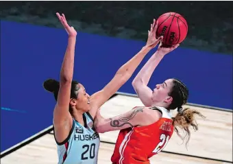  ?? CHARLIE RIEDEL/AP PHOTO ?? UConn’s Olivia Nelson-Ododa blocks a shot by Syracuse’s Emily Engstler during Tuesday’s NCAA tournament game at the Alamodome in San Antonio. Defense has become a real key for the Huskies, who play Iowa today in the Sweet 16.