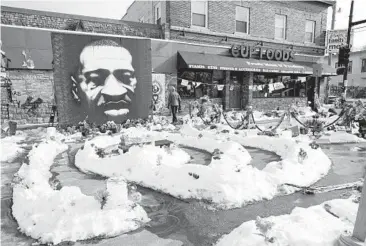  ?? JIM MONE/AP ?? George Floyd Square is shown Feb. 8 in Minneapoli­s. Ten months after Floyd’s death at the hands of police, the square remains a makeshift memorial. The trial of former police Officer Derek Chauvin is slated to begin with jury selection Monday.