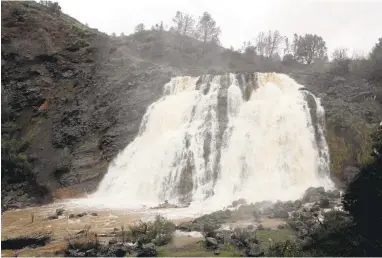  ?? JIM GENSHEIMER/STAFF ?? A waterfall dances over the spillway Saturday below Anderson Reservoir in Morgan Hill. It is the first spillover since 2006.