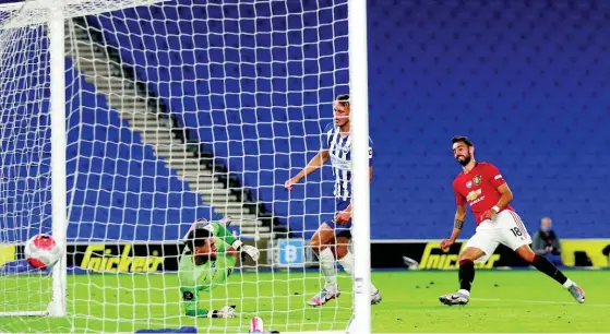  ?? AP ?? Manchester United’s Bruno Fernandes (right) scores his side’s third goal during the English Premier League match between Brighton & Hove Albion and Manchester United at the AMEX Stadium in Brighton, England, on Tuesday, June 30, 2020.