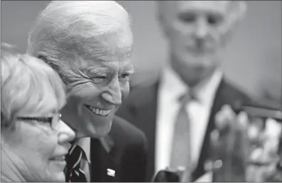  ?? [MEG KINNARD/THE ASSOCIATED PRESS] ?? Democratic presidenti­al candidate and former Vice President Joe Biden poses for photos with supporters after a campaign stop in Sumter, S.C.