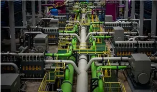  ?? ?? A worker walks over the pipeline that transports seawater to   lters at Europe's largest desalinati­on plant for drinking water located in Barcelona.