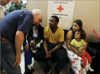  ?? DARRON CUMMINGS — THE ASSOCIATED PRESS ?? Republican vice presidenti­al candidate, Indiana Gov. Mike Pence, talks with people at a Red Cross shelter, Thursday in Kokomo, Ind. The shelter housed those whose homes were damaged by tornados that passed through the area Wednesday afternoon.