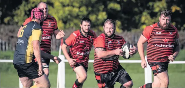  ?? Sharon McLean ?? Widnes prop-forward Justin Winstanley charges forward against Didsbury Toc H last Saturday afternoon. Widnes trailed 14-0 at the interval but hit back in the second period to win the game 19-14. See full report on the opposite page.