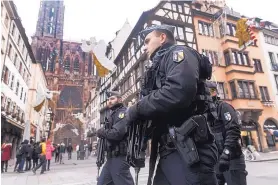  ?? JEAN FRANCOIS BADIAS/ASSOCIATED PRESS ?? French police officers patrol next to Notre-Dame cathedral of Strasbourg on Wednesday after a shooting in the city Tuesday night.